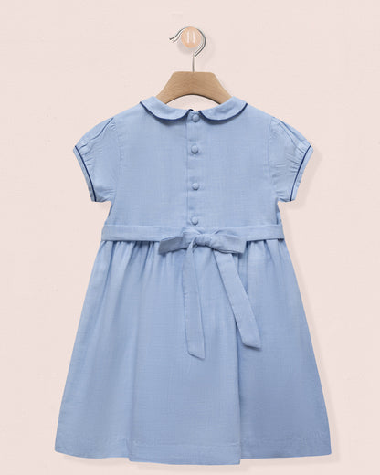 Blue dress with a collar on a beige background