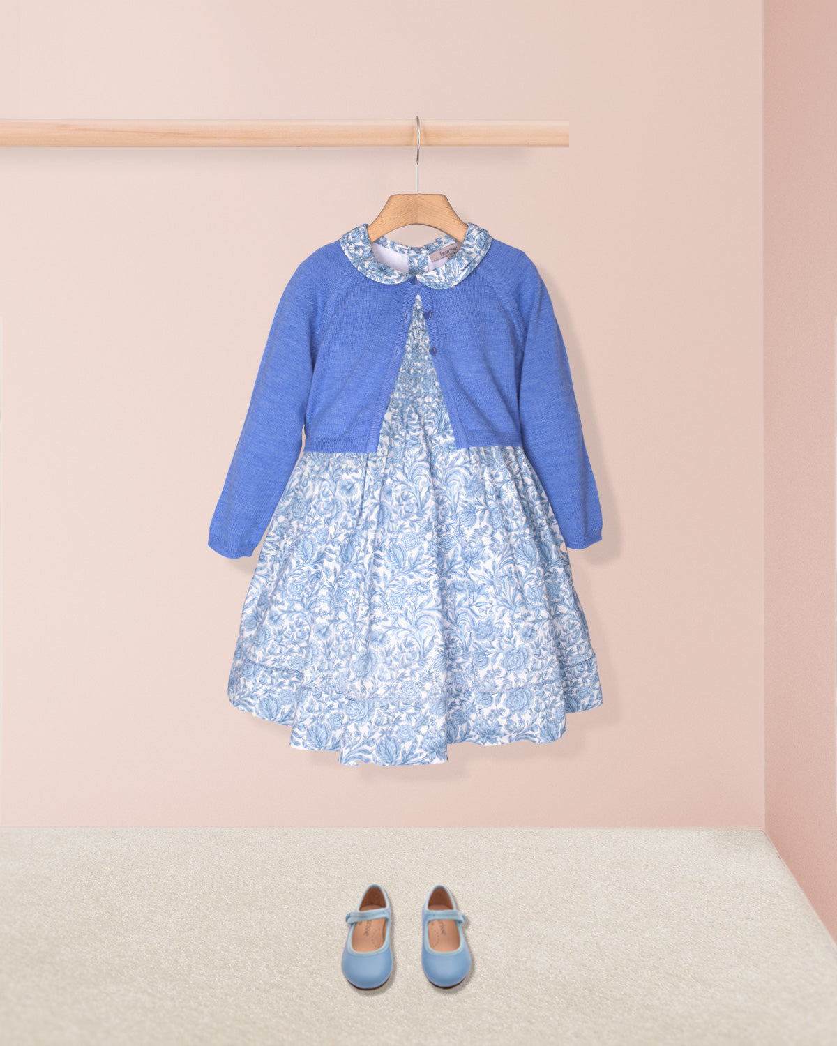 Blue dress with floral pattern on a pink background