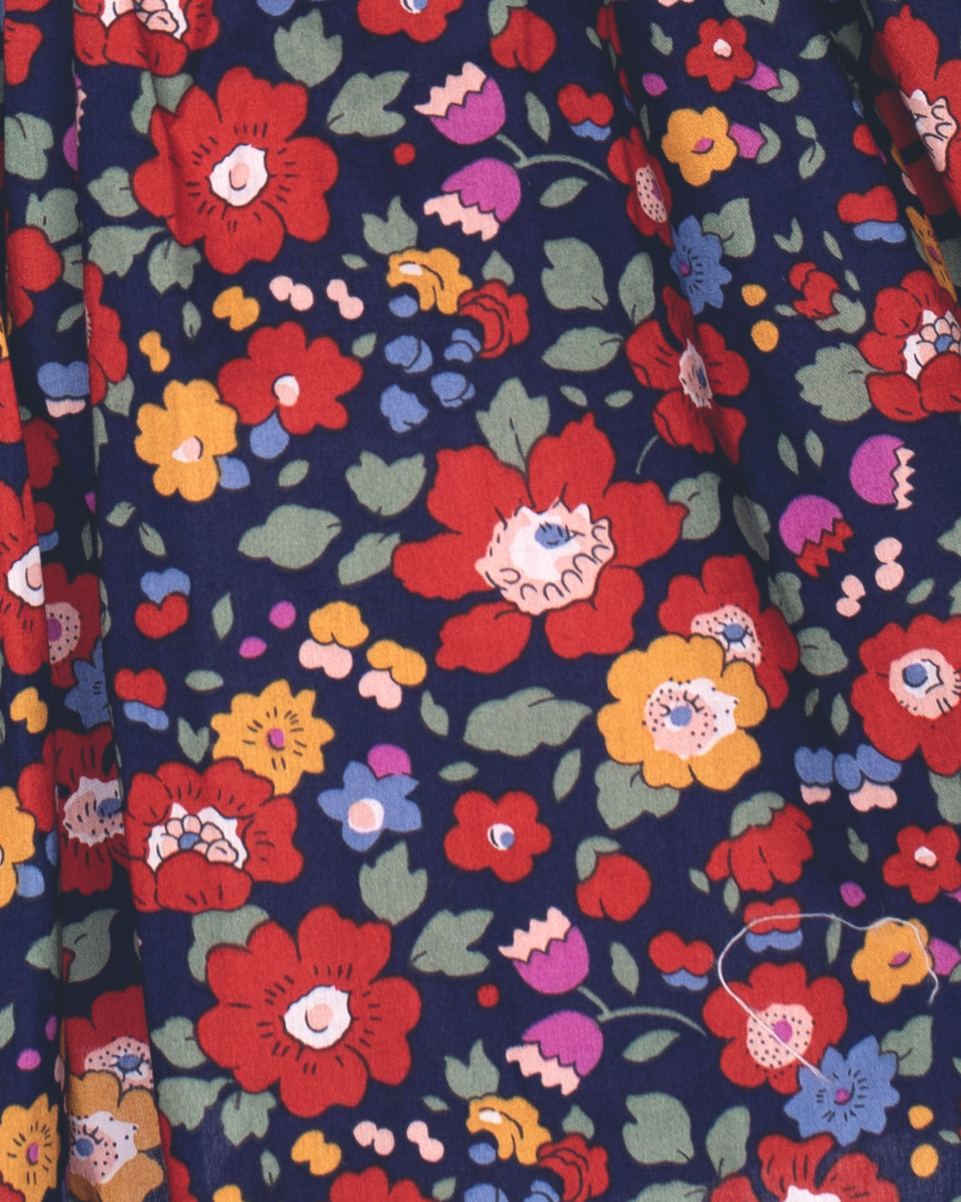 Close-up of a fabric with colorful floral pattern on a navy background