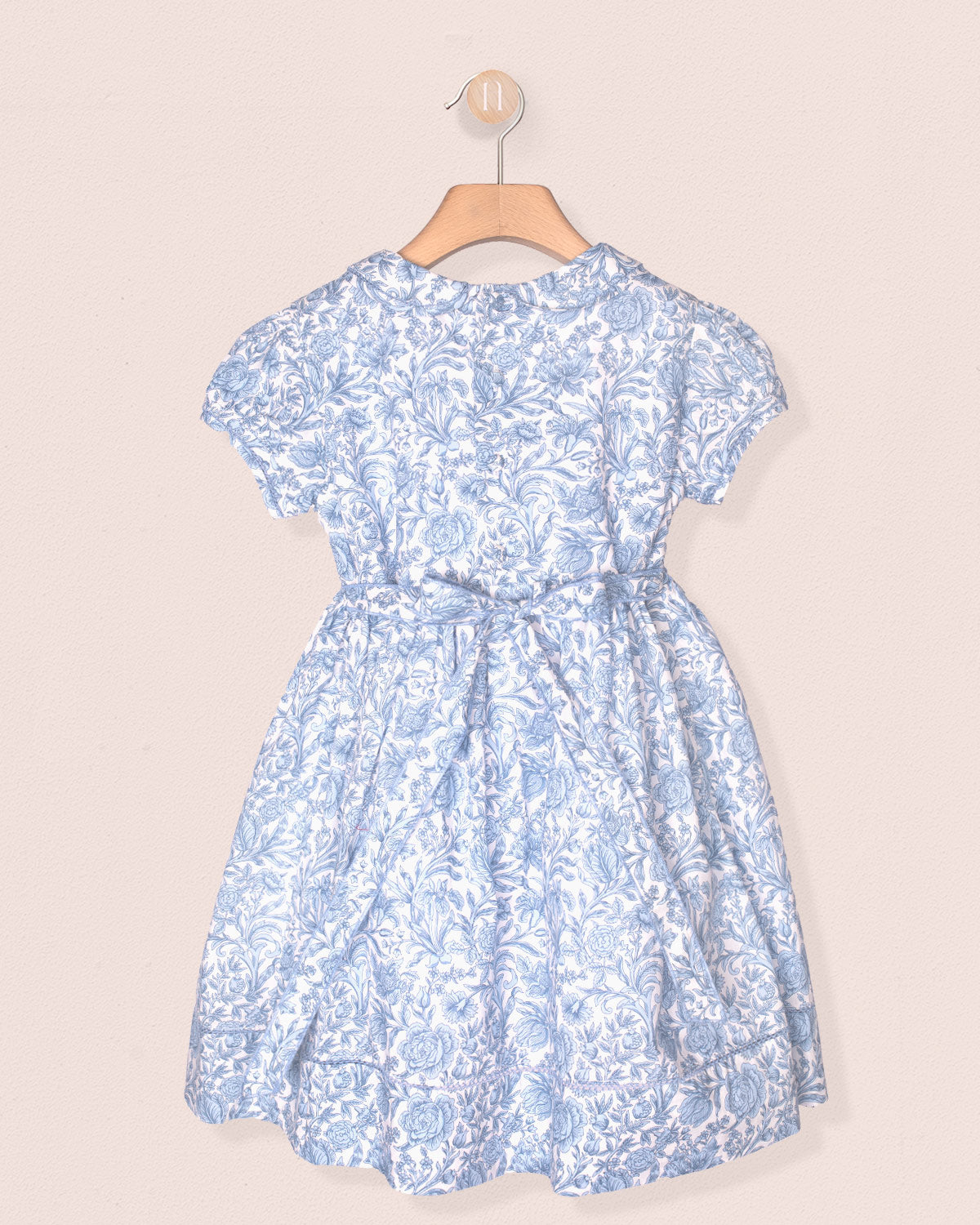Blue floral dress on a beige background