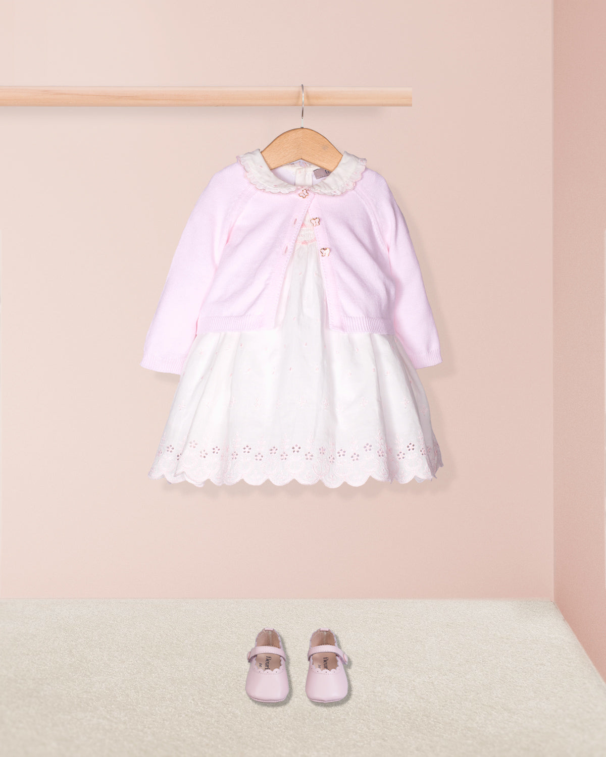 Pink and white dress with matching shoes on a pink background