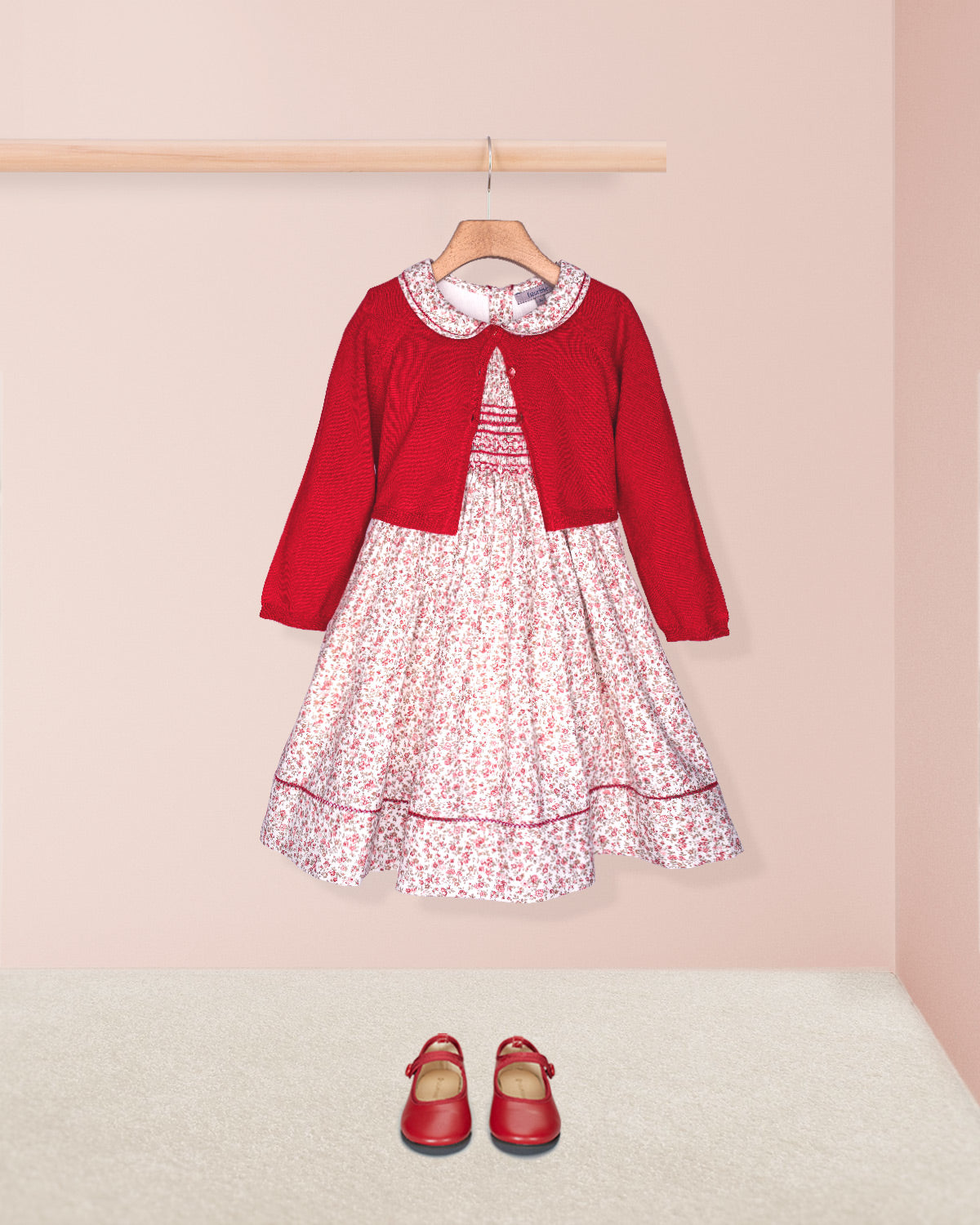 Red dress with floral pattern and matching shoes on a pink background