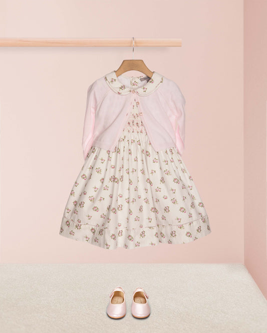 Floral dress with pink cardigan and shoes on a pink background