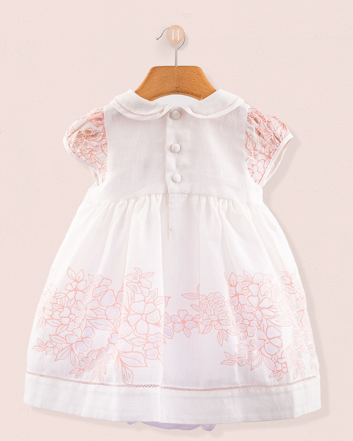 Back view of Baby Emmy Doppia Pink Smock Set highlighting pearl buttons and scalloped collar on white cotton
