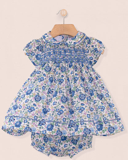 Baby Emmy Liberty Blue Rosebud Mini Dress Set features a floral print dress with peter-pan collar, smocked bodice, and matching bloomer, elegantly crafted with entre-deux stitching.