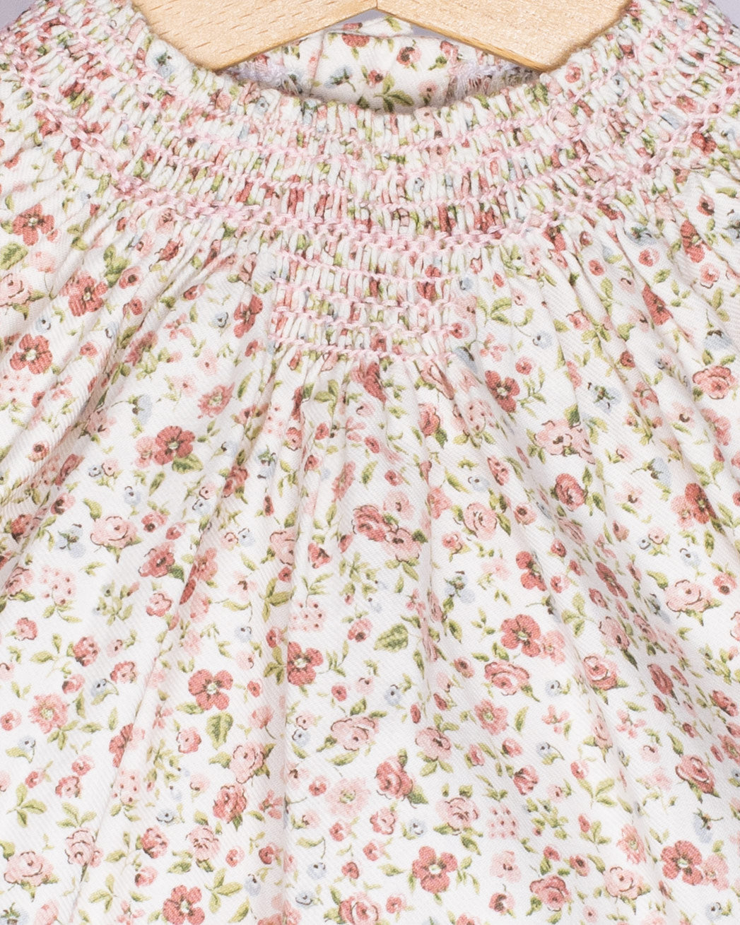 Floral patterned fabric with pink flowers on a white background