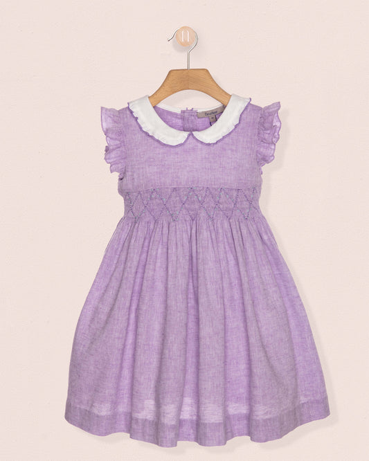 Purple dress with white collar on a beige background