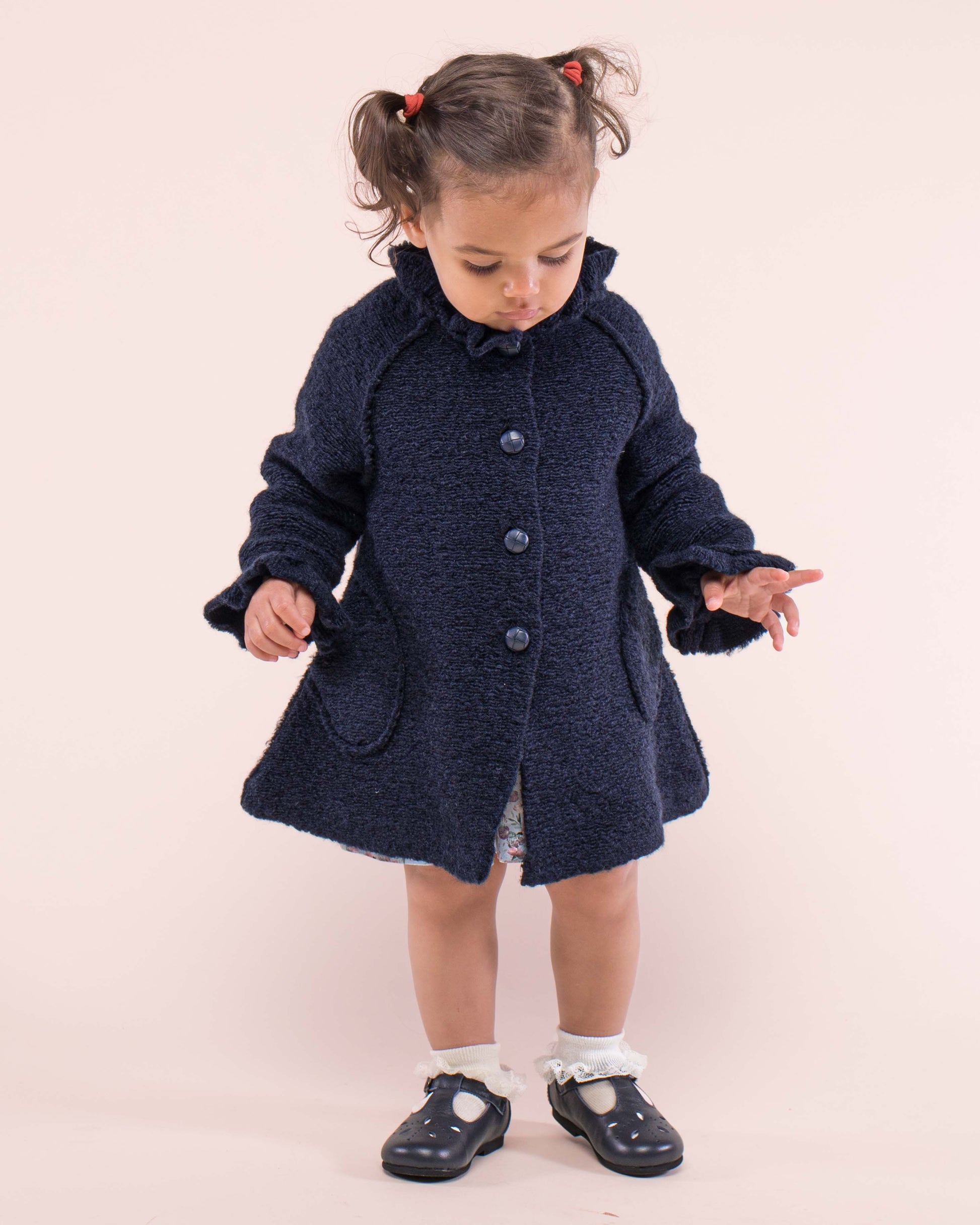 Girl wearing the Fluffy Navy Coat standing up showing the front of the dress