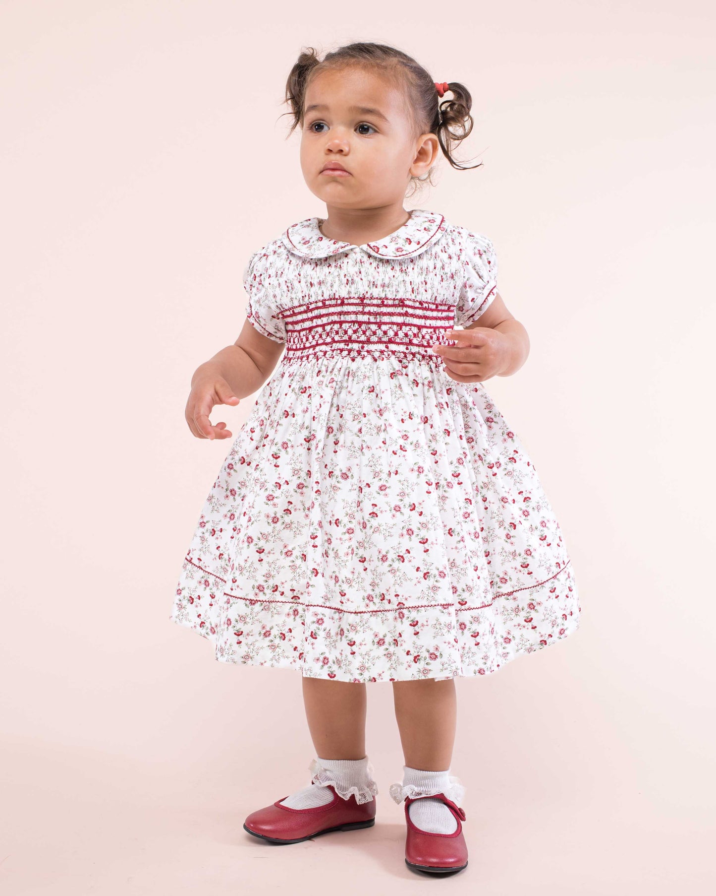 Girl wearing Emma Italian Red Floral Flannel Dress standing up showing the front of the dress