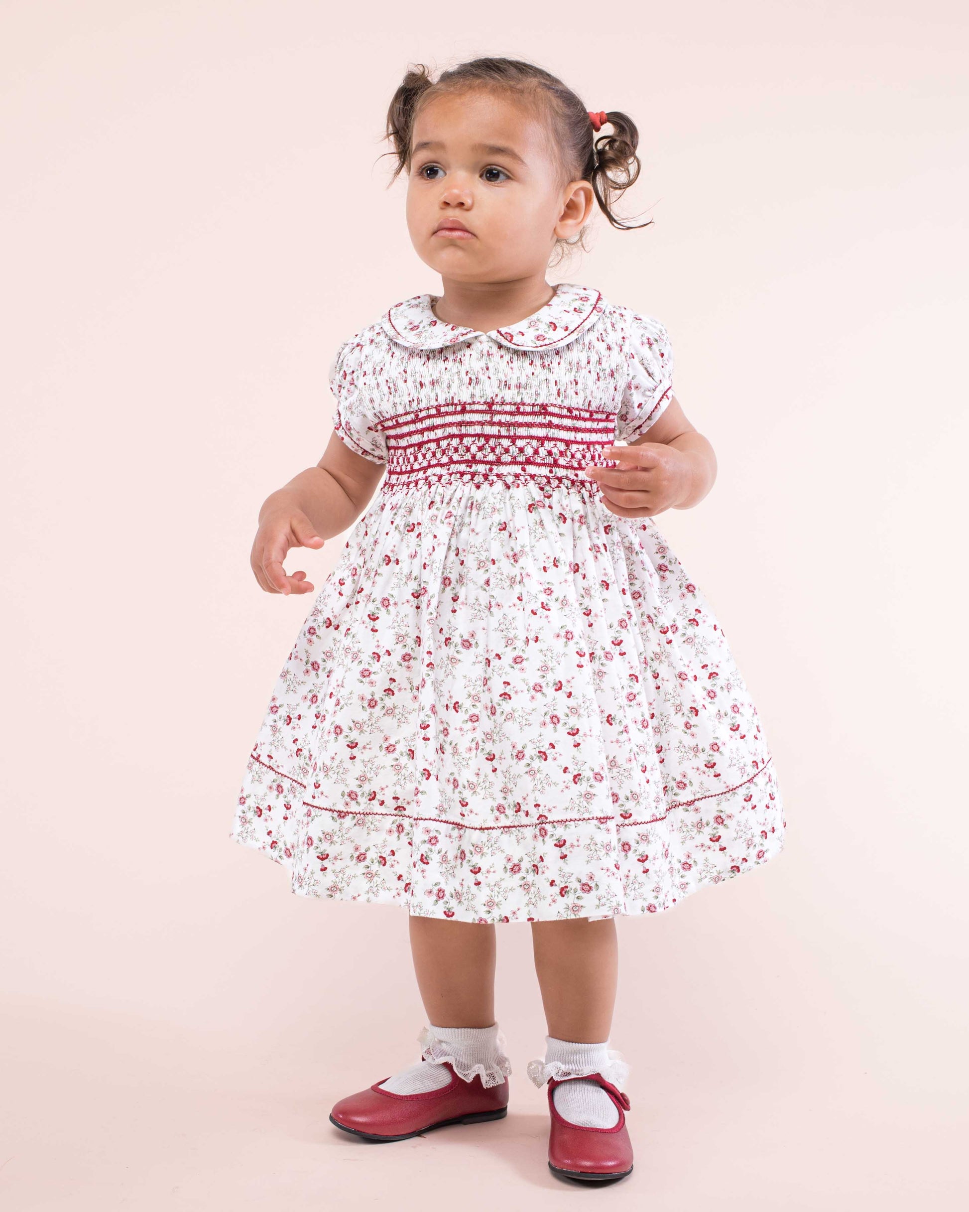 Girl wearing Emma Italian Red Floral Flannel Dress standing up showing the front of the dress