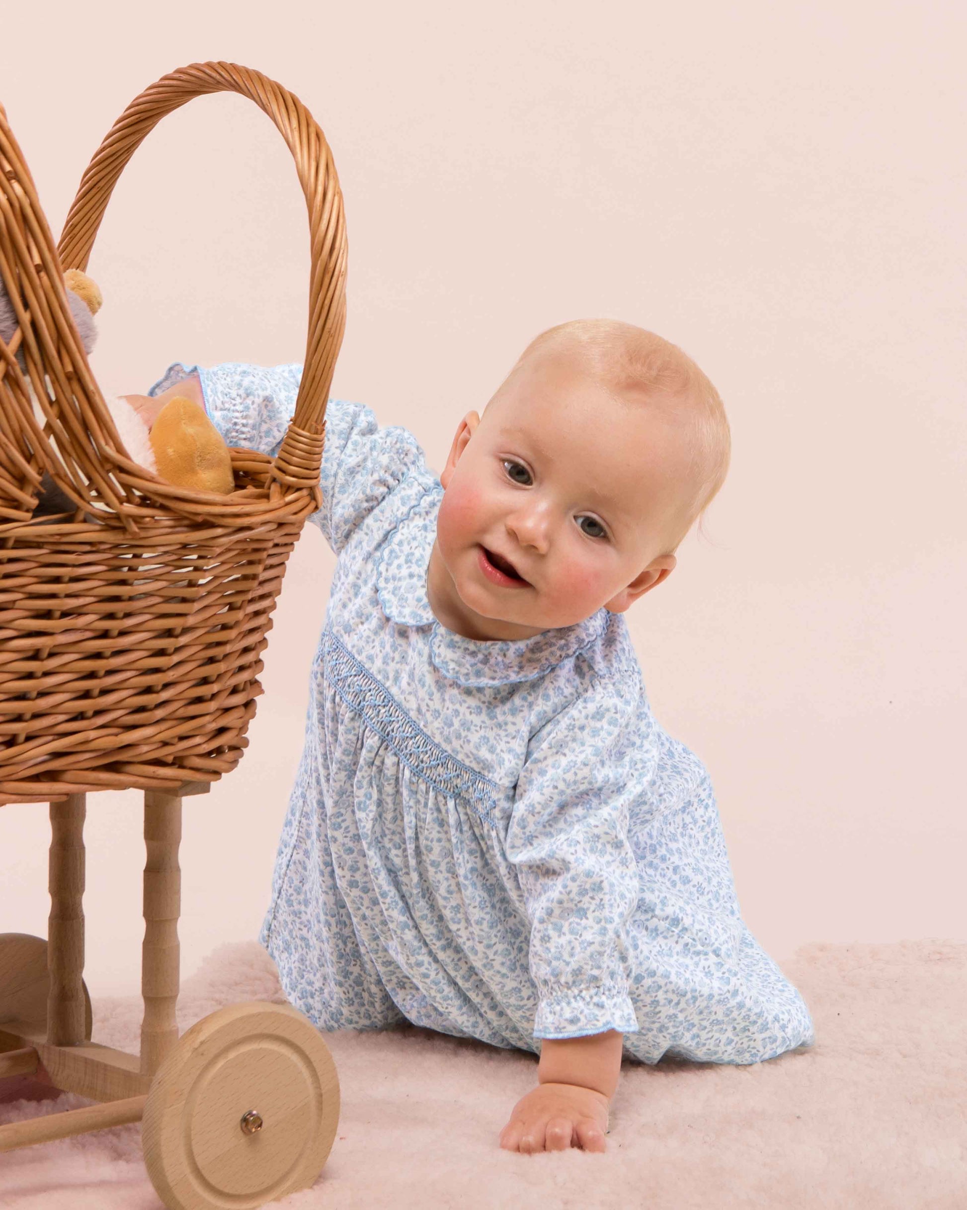 Baby crawling on the floor wearing Baby Madeline dress showing the front of the dress