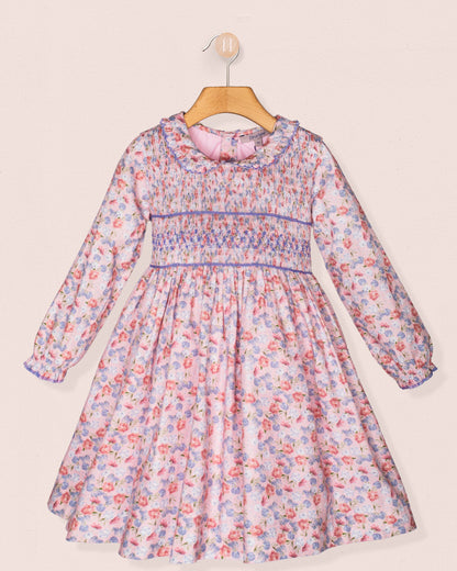 Floral dress on a hanger against a light background
