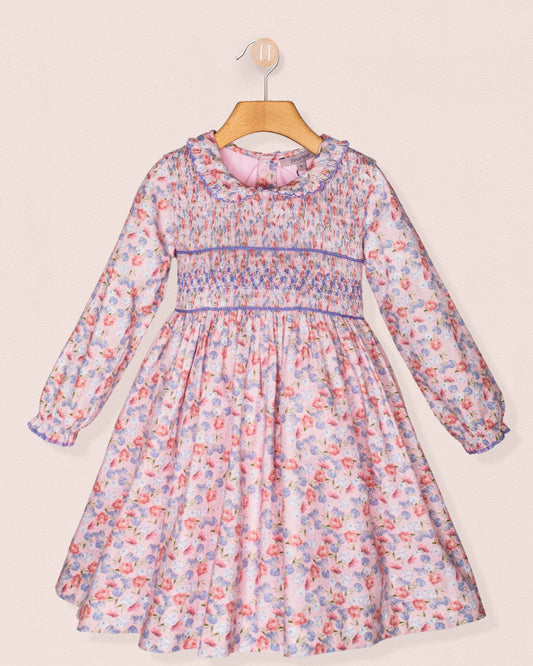 Floral dress on a hanger against a light background