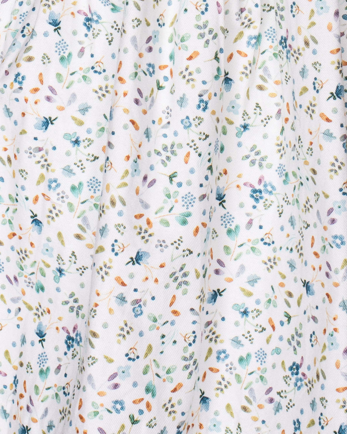 Floral patterned fabric with small flowers in various colors on a white background