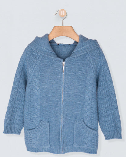 Blue knitted hoodie with a zipper on a wooden hanger against a light gray background