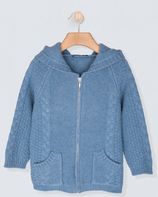 Blue knitted hoodie with a zipper on a wooden hanger against a light gray background