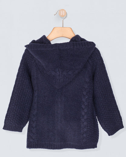 Navy blue knitted cardigan on a hanger against a light gray background