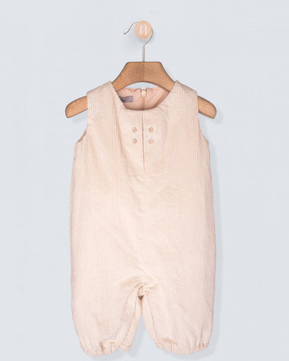 Beige baby romper on a hanger against a light gray background