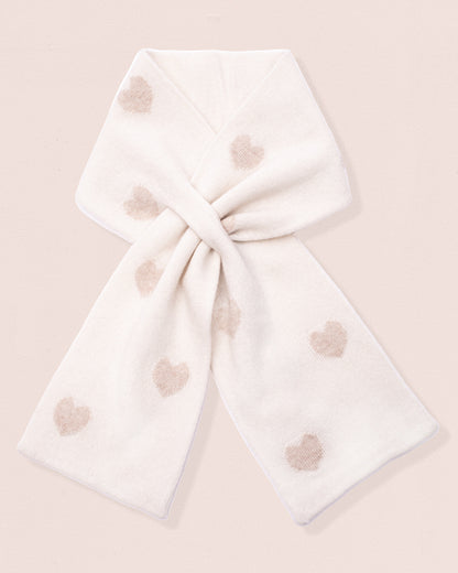 White scarf with gold-hue heart patterns tied on a light pink background