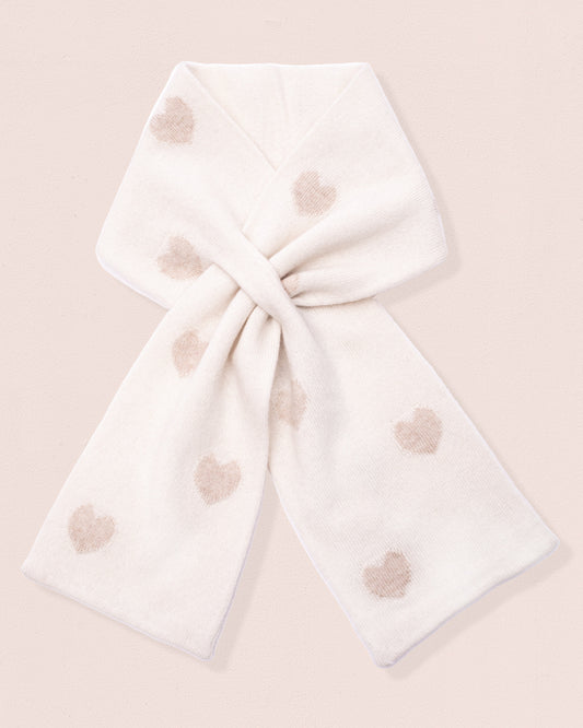 White scarf with gold-hue heart patterns tied on a light pink background