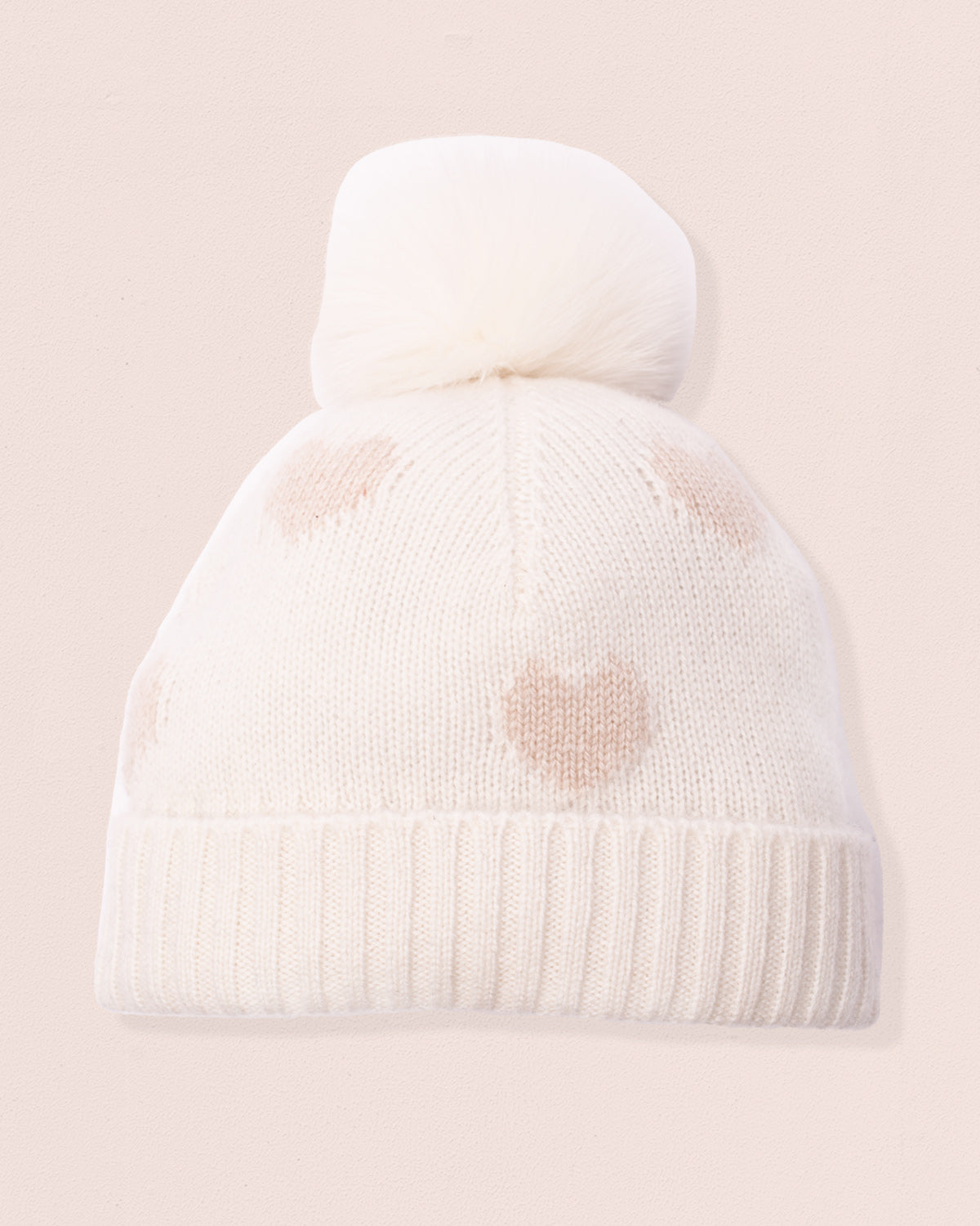 Cream colored cashmere winter hat with a pomp pom and golden heart shapes