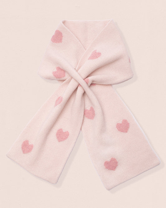 Light pink cashmere scarf with pink heart patterns on a light pink background