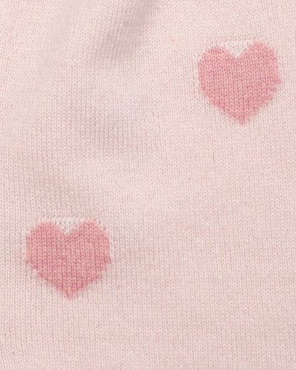 Close-up of pink heart patterns on a light pink fabric background