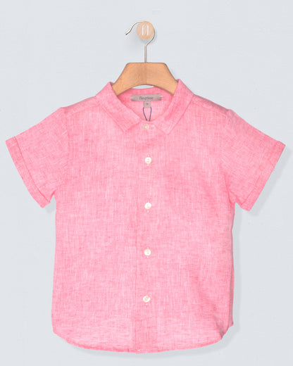 Pink short-sleeve shirt on a hanger against a light gray background