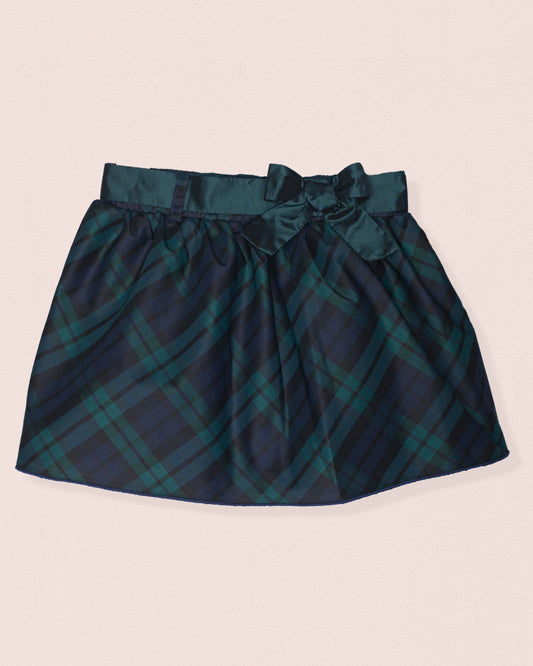 Front of a skirt with black watch plaid design, bow, with green and black color