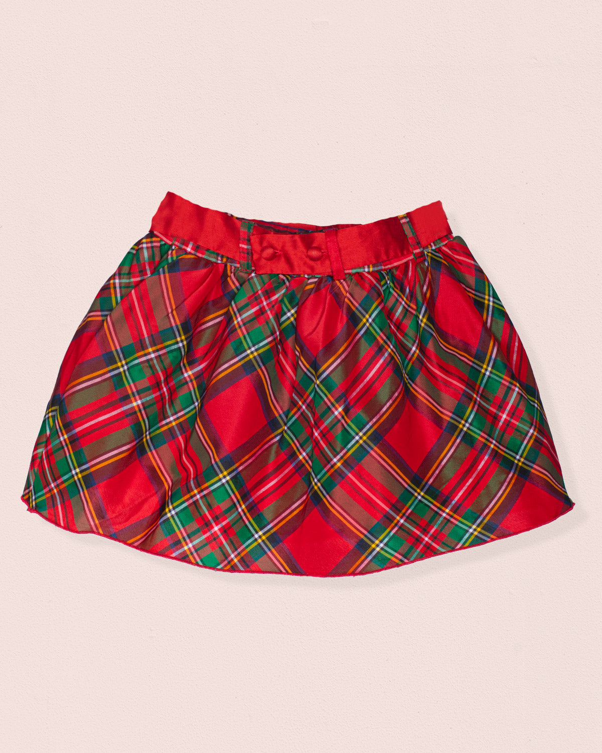 Back of red plaid skirt on a beige background