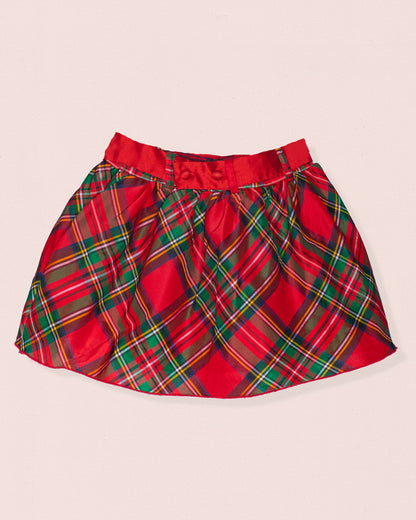 Back of red plaid skirt on a beige background