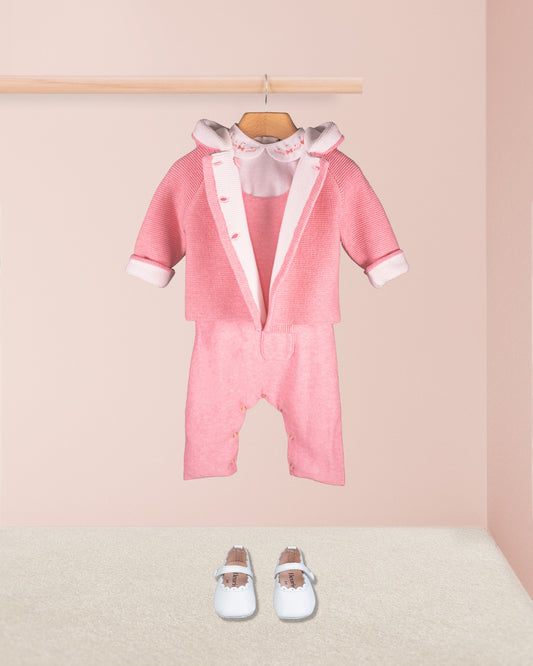 Aspen Candy Mélange pink knit overall styled with matching knit jacket white collared onesie and white shoes