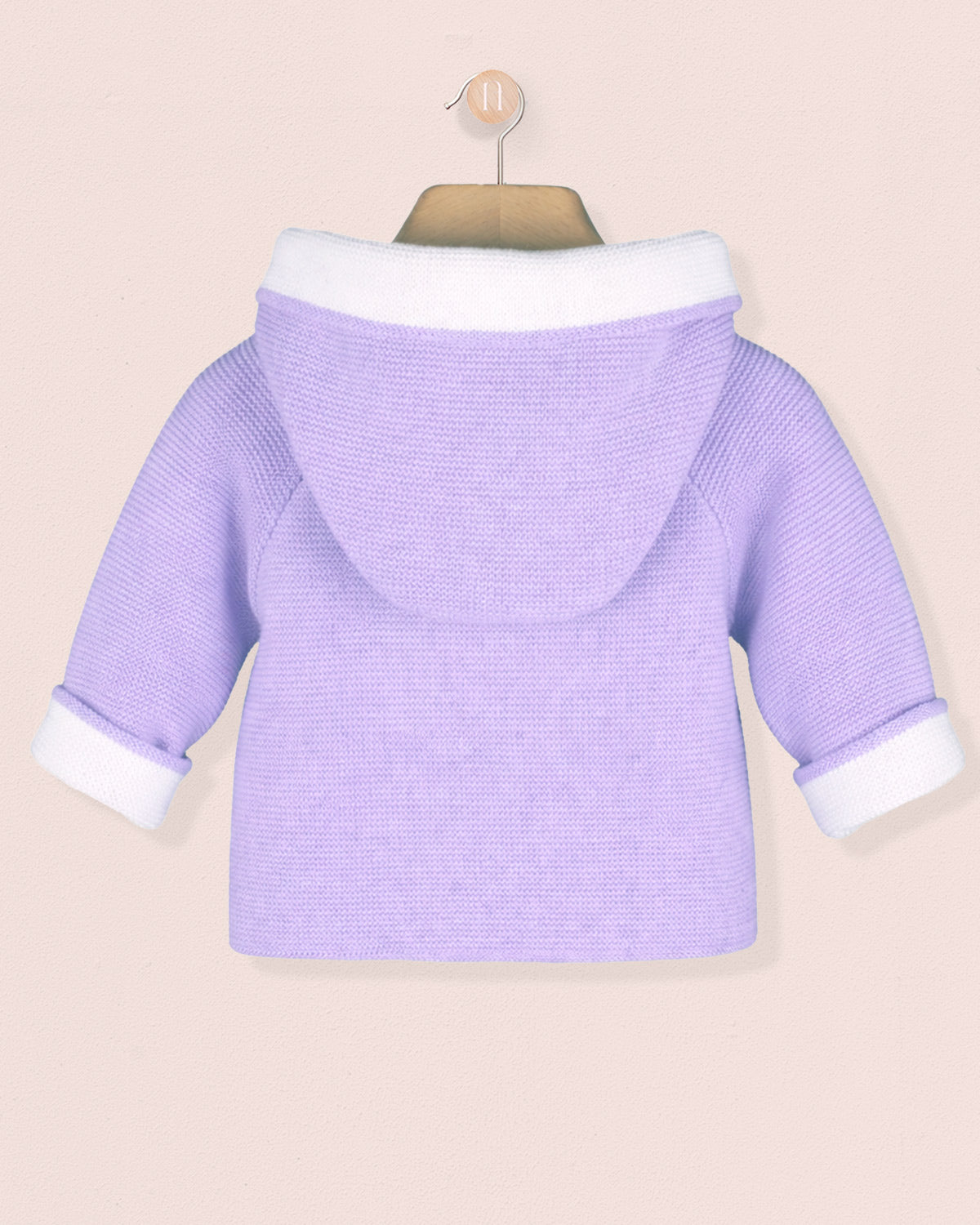 Purple baby sweater with white trim on a beige background