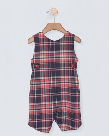 Plaid dress on a hanger against a light gray background