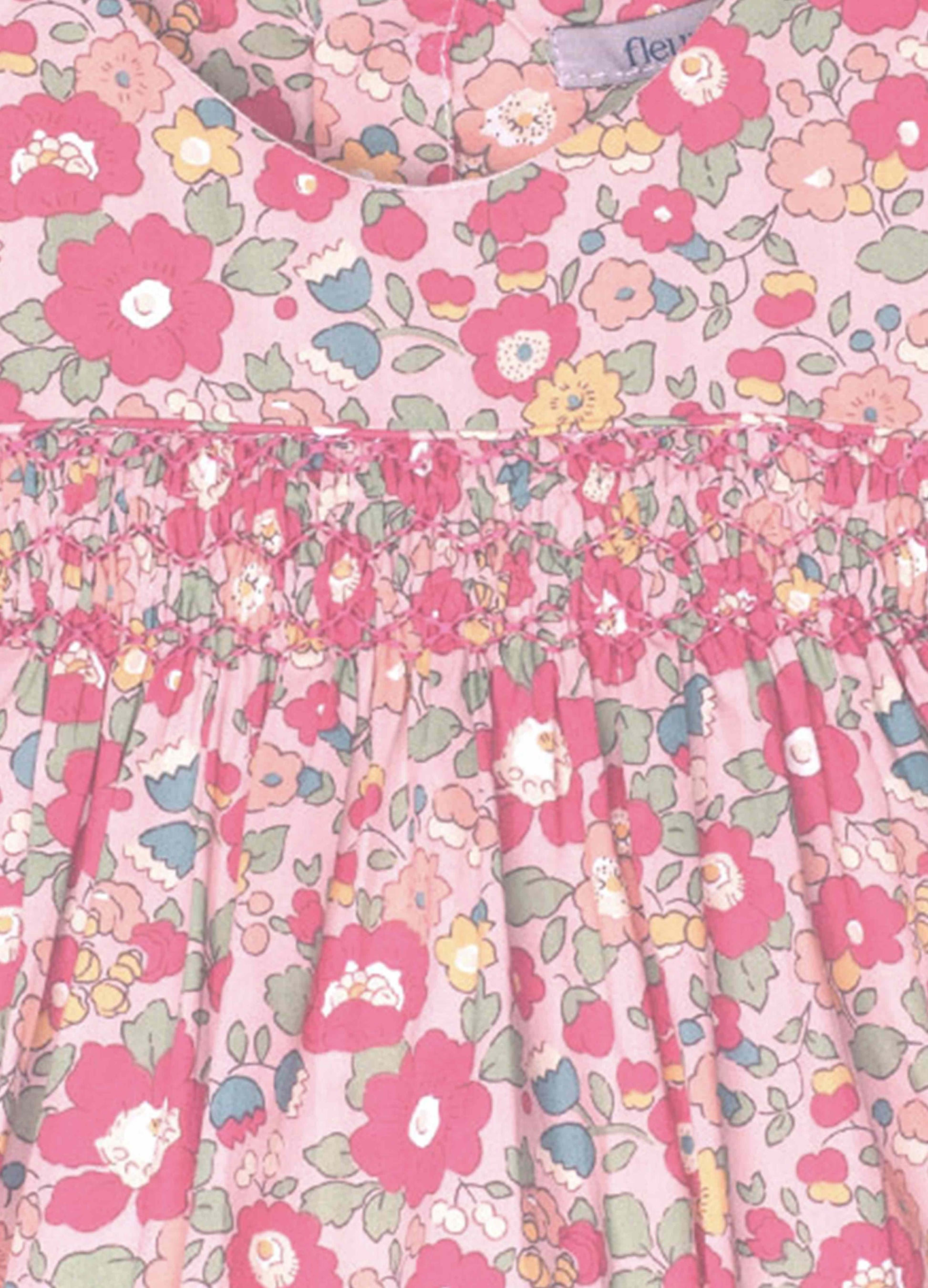Floral patterned fabric with pink flowers on a light pink background