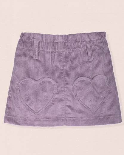 Purple corduroy skirt with heart shapes on a beige background