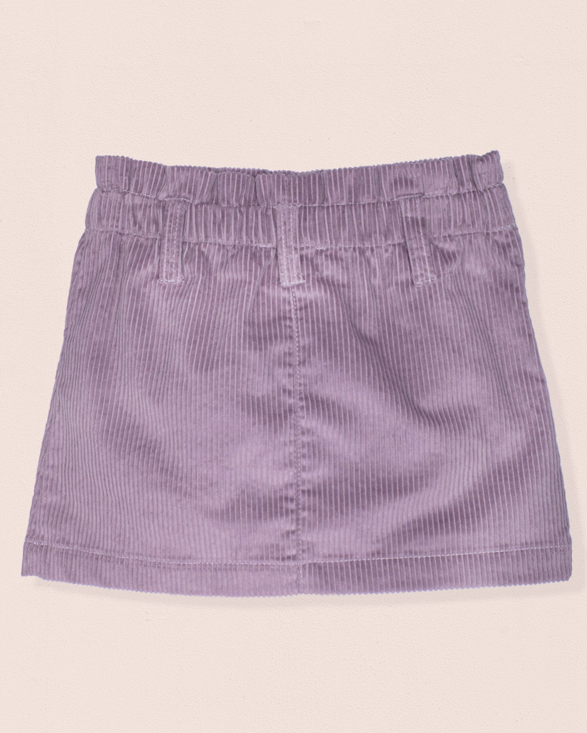 Purple corduroy skirt on a beige background