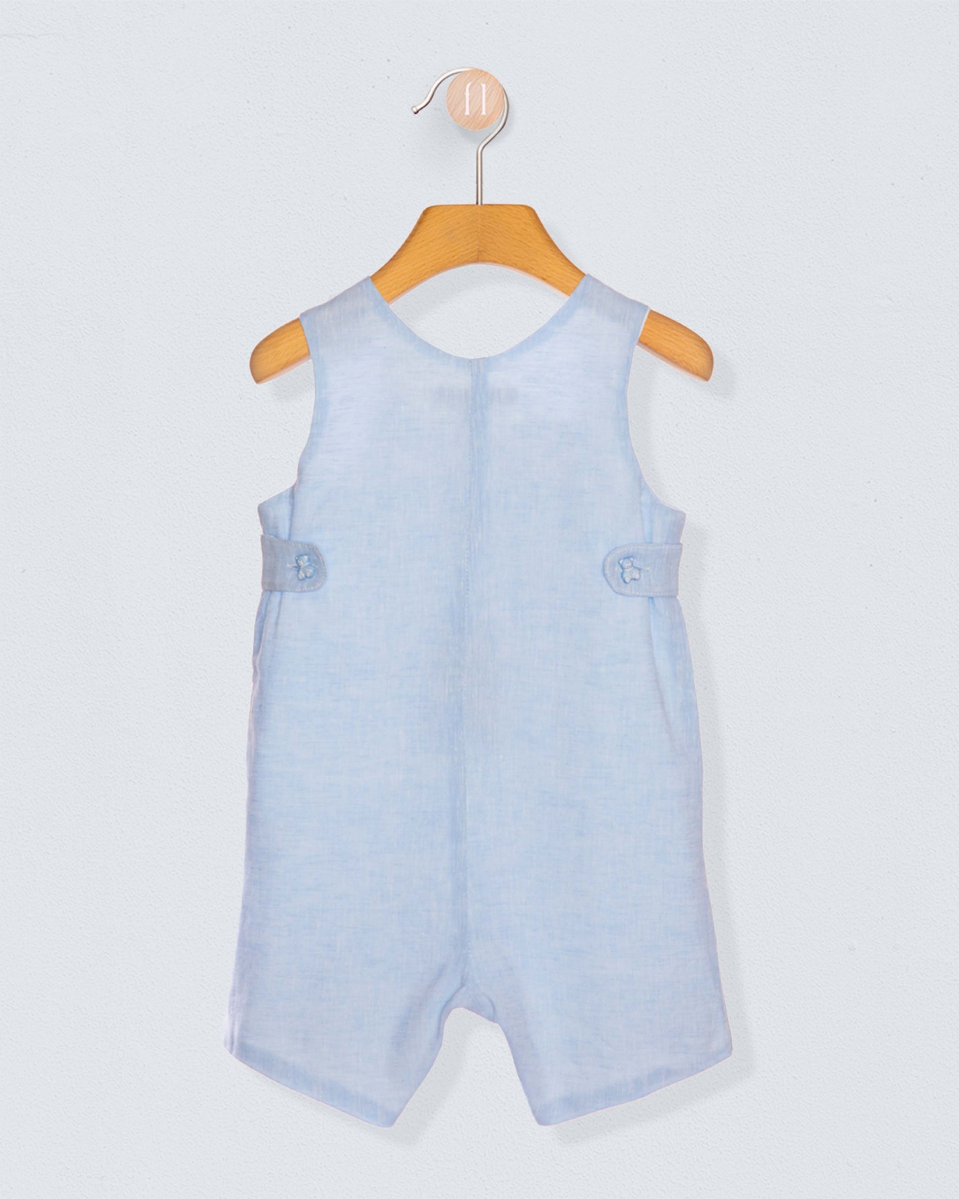 Back of light blue baby romper on a wooden hanger against a light gray background