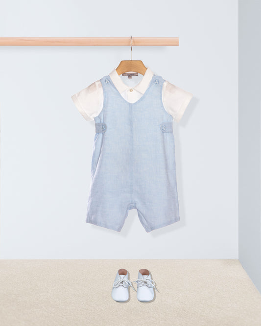 Light blue striped romper with white shirt on a hanger against a light gray background.