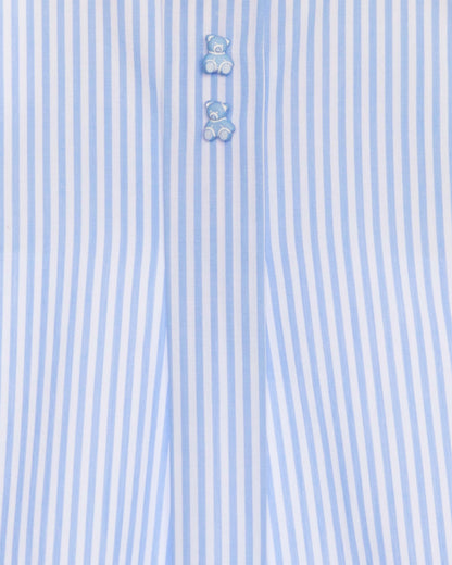 Close-up of a light blue and white striped shirt with teddy bear buttons.