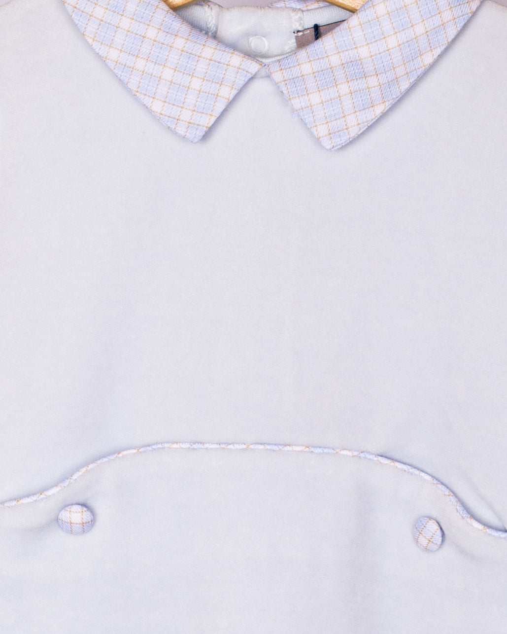Detail close-up of the checkered Peter Pan collar and waist piping on the light blue velour footie, showing fabric texture and stitching.
