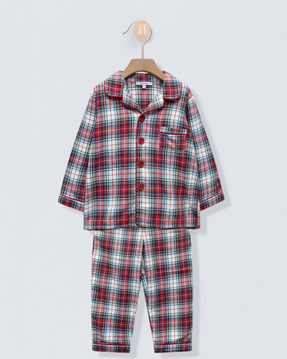 Plaid pajama set on a hanger against a light gray background