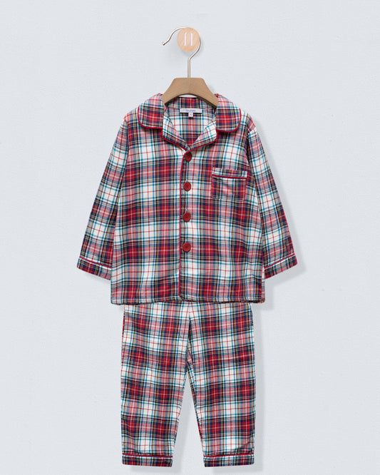 Plaid pajama set on a hanger against a light gray background
