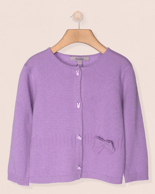 Purple cardigan on a wooden hanger against a beige background