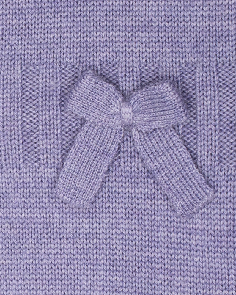 Close-up of a purple knitted fabric with a bow detail