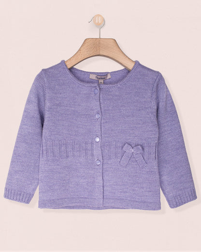 Purple knitted cardigan with a bow on a beige background