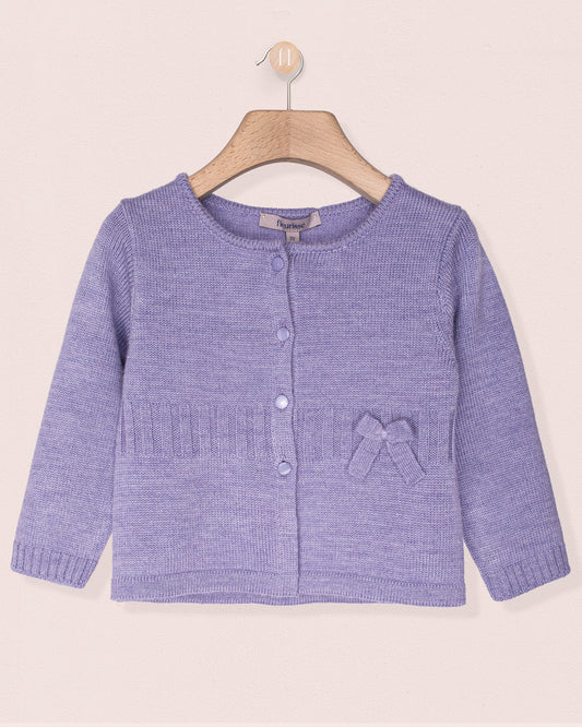 Purple knitted cardigan with a bow on a beige background