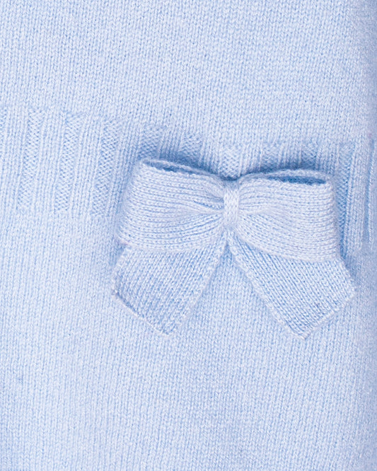 Close-up of a light blue knitted sweater with a bow detail.