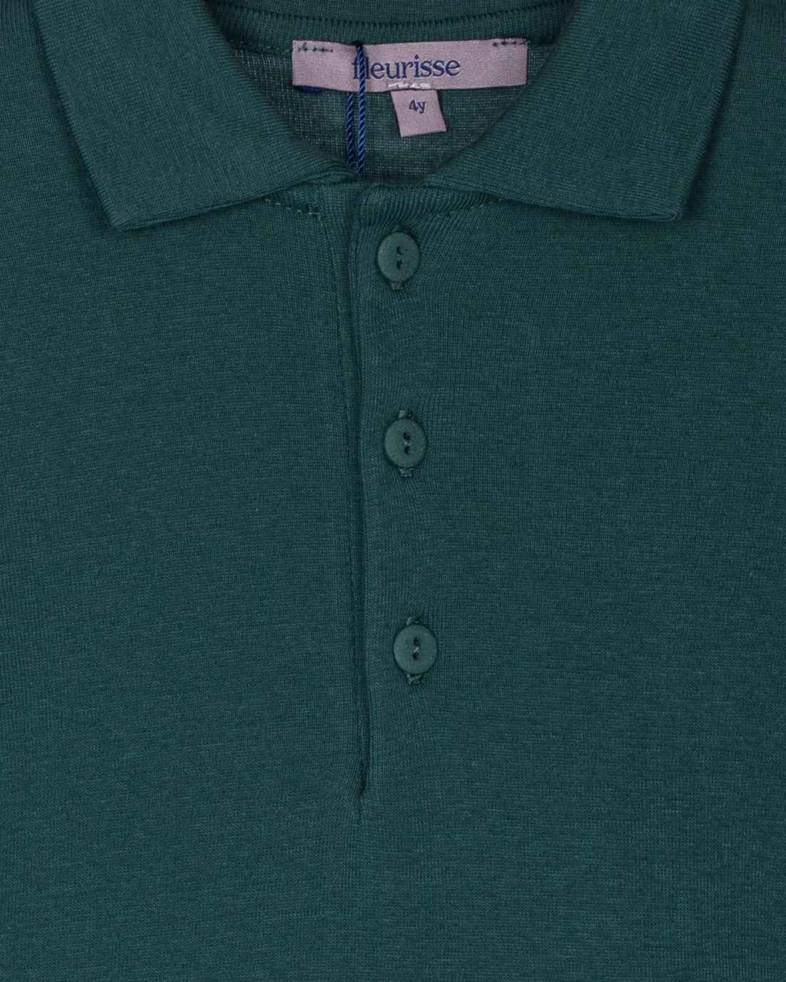 Close-up of the hunter green polo shirt showcasing the brushed cotton texture, soft point collar, and three high-quality corozo buttons on the placket.