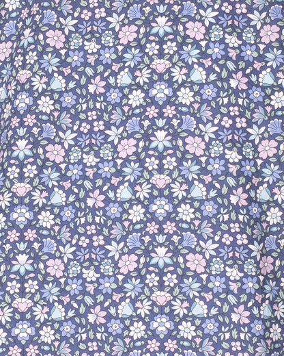 Floral pattern with small flowers in pastel colors on a blue background